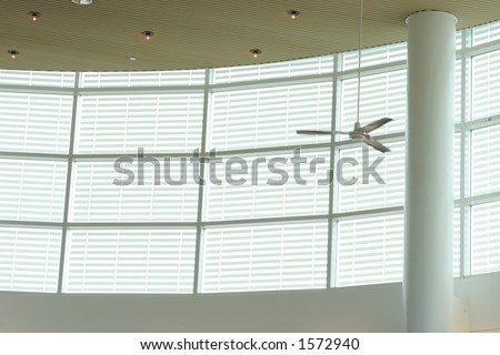 Large white circular window and ceiling fan