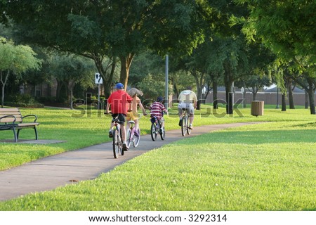 Family biking together in a park in Sugar Land, Texas