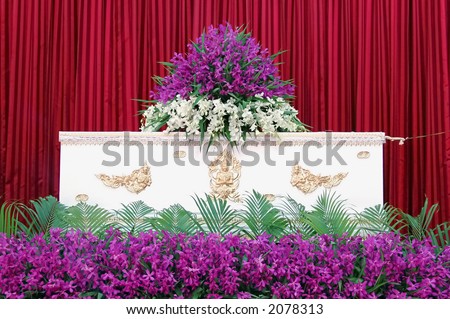 White coffin with flowers at a Thai funeral