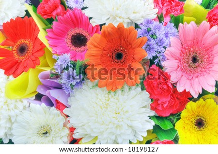 A colorful bouquet of mixed flowers and ribbons