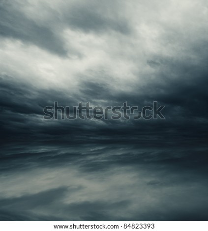 Heavy dark gray clouds reflected in sea