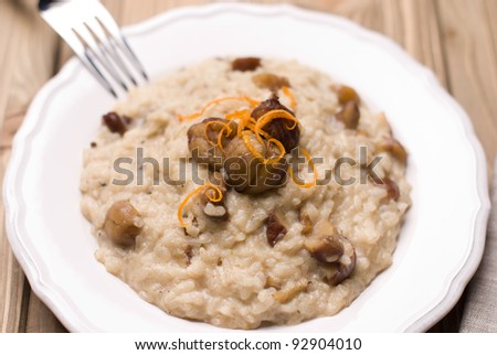 Dish with chestnut risotto with blue cheese on a wooden background