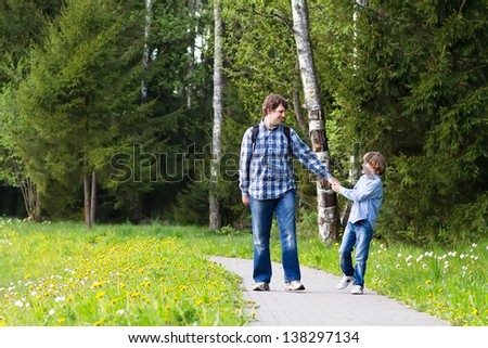 Father and son enjoying a walk in the forest