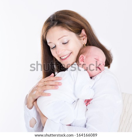 Young mother holding her newborn sleeping baby Young mother holding her newborn sleeping baby