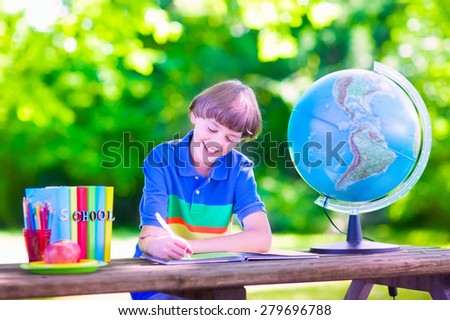 Child in school yard. Kids study. Happy laughing teenager student boy in the school garden reading books and having apple for healthy snack, back to school concept