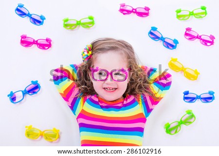 Child wearing eye glasses. Eye wear for kids. Little girl choosing spectacles. Lens and colorful frame choice for children. Vision and sight control at optician shop. Smart preschooler with eyeglasses