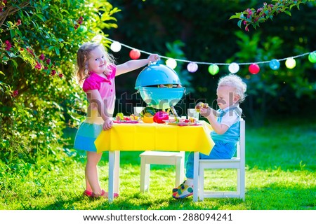 Children grilling meat. Family camping and enjoying BBQ. Brother and sister at barbecue preparing steaks and sausages. Kids eating grill and healthy vegetable meal outdoors. Garden party for child.