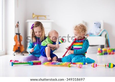 Children with music instruments. Musical education for kids. Colorful wooden art toys. Little girl and boy play music. Kid with xylophone, guitar, flute, violin. Early development for toddler and baby