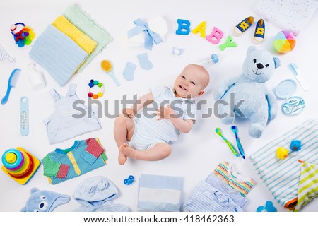Baby on white background with clothing, toiletries, toys and health care accessories. Wish list or shopping overview for pregnancy and baby shower. View from above. Child feeding, changing and bathing