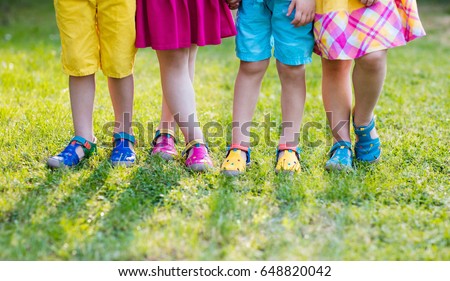 Footwear for children. Group of preschool kids wearing colorful leather shoes. Sandal summer shoe for young child and baby. Preschooler playing outdoor. Child clothing, foot wear and fashion.