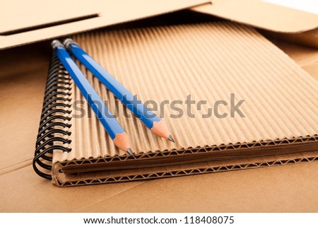 Notepad, blue pencils and paper folder