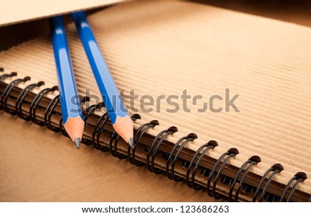 Notepad, blue pencils and paper folder