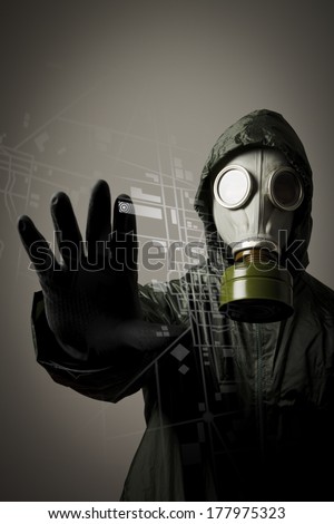Man wearing a gas mask on his face. Gas mask and city map. Evacuation concept.