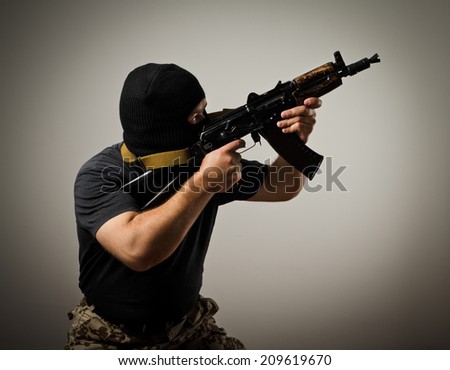 Man in mask with gun. Terrorist.