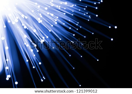Fiber optics in blue tones on black background, selective focus