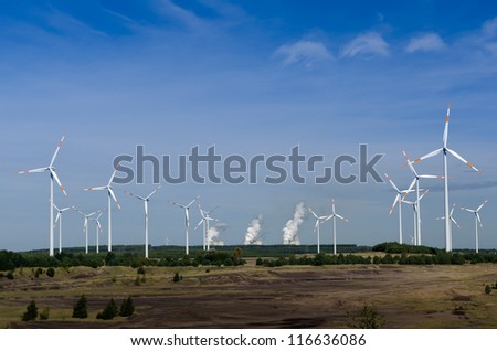 Wind turbines in front of a coal-fired plant