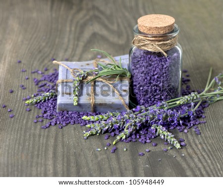 herbal lavender soap and  bath salt with fresh flowers over wooden background