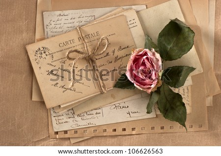 dry rose and old letters. vintage postcards and envelopes