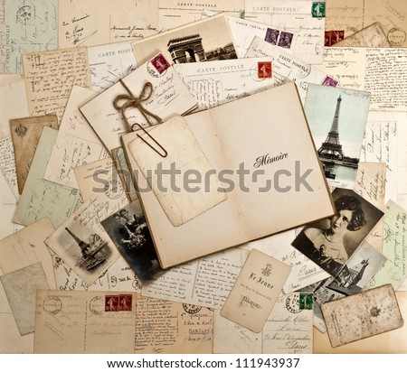 old letters, french post cards and empty open book. nostalgic vintage background
