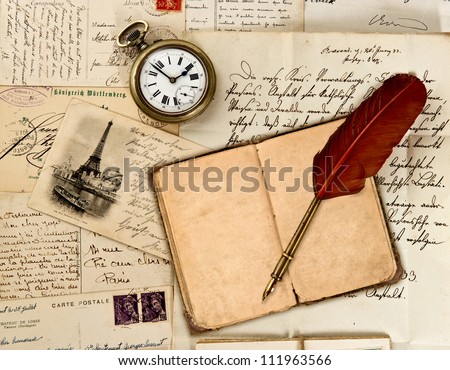 travel book diary, old letters, post cards and feather quill. nostalgic vintage background