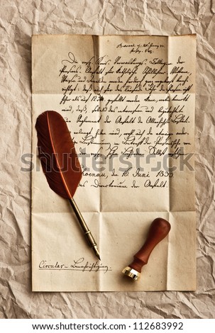 old letter with feather quill and wax seal. vintage background