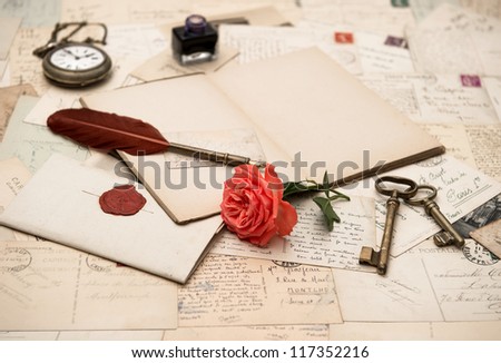 open book, old accessories and postcards. romantic vintage background. selective focus