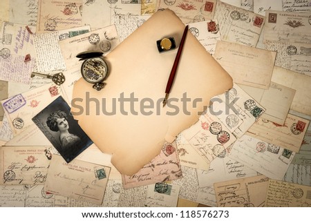 blank piece of antique paper, old accessories and postcards. sentimental vintage background