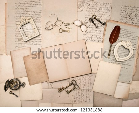 vintage things, glasses, keys, open book, old letters and photo frames. nostalgic sentimental paper background