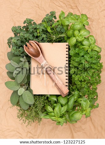 empty recipe book with variety fresh herbs and decoration. cooking background