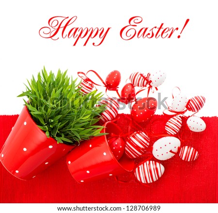 colorful white red painted easter eggs with green grass over table cover. festive composition with sample text Happy Easter!