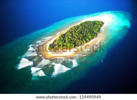 top view of tropical island in turquoise blue water. maldives panoramic landscape