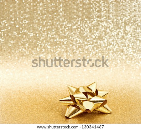 beautiful golden ribbon bow on shiny background