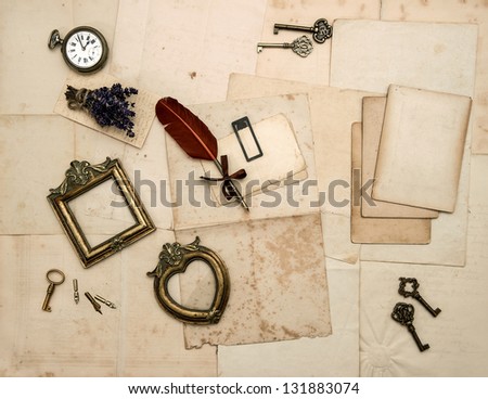 nostalgic sentimental background with vintage accessories, old letters, pages, photo frames, glasses, keys, clock and dry lavender flowers