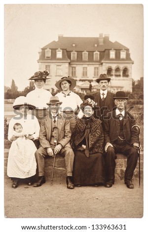 BERLIN, GERMANY - CIRCA 1905: antique portrait of a wealthy family with its house on background, circa 1905 in Berlin, Germany