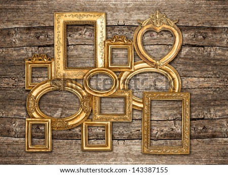 antique golden framework rustic wooden wall. vintage background. empty baroque frame for photo and picture