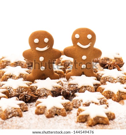 gingerbread man cookie, cinnamon stars and star anise on wooden background. christmas bakery