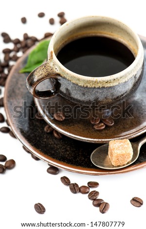 Cup of black coffee with beans on white background. Food and Drinks. Selective focus