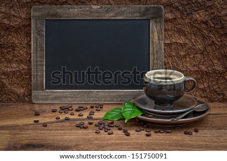 cup of coffee and antique blackboard. coffee leaves and beans. retro style image