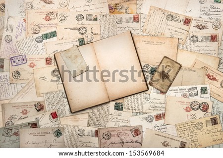 nostalgic vintage background with old handwritten postcards and open empty book