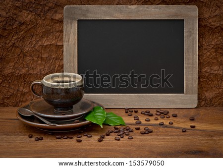 cup of coffee and antique blackboard. coffee leaves and beans. retro style image