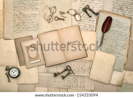 open book, antique accessories, old letters, post cards, glasses, keys, clock. nostalgic background. memories. vintage style picture