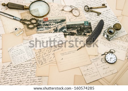 antique accessories, old letters and postcards, vintage ink pen. nostalgic sentimental background. ephemera