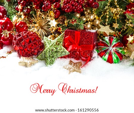 festive decoration with baubles, golden garlands, christmas tree and red berries branches. holidays background with sample text Merry Christmas!