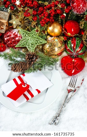 festive christmas table place setting decoration with red heart shaped candle. candle light dinner. colorful holidays background