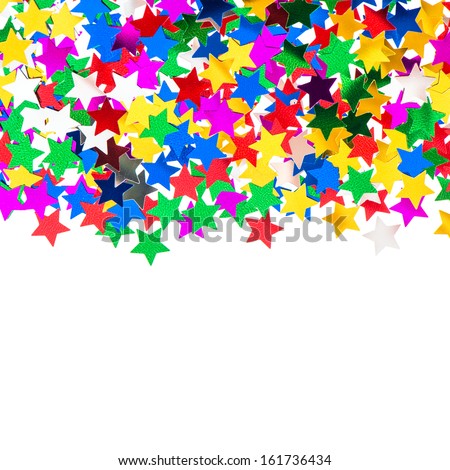 star shaped red, blue, green, gold confetti on white background. festive colorful background