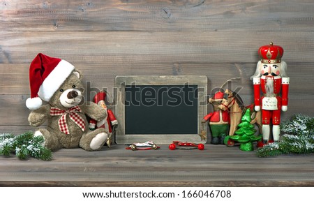 nostalgic christmas decoration with antique toys and blackboard for your text. retro style toned picture