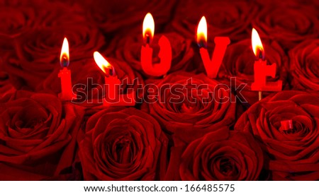 red roses and burning candles making I LOVE. Festive flower arrangement. selective focus