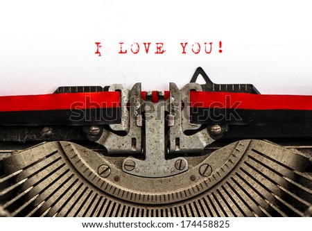 Old typewriter with sample text I LOVE YOU! Red words on white paper. Valentines Day card
