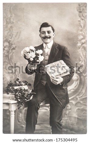 France, Paris - Circa 1920: Portrait Of Young Man With Rose Flowers And Gift. Typical For This Period Mans Look. Congratulations. Valentines Day. Birthday