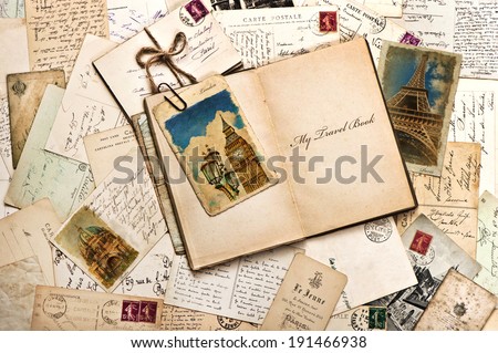 old postcards, letters, mails and open journal with sample text My Travel Book. vintage style travel background